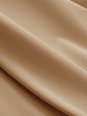 Close-up texture of light khaki breathable casual slacks with 4 pockets fabric showing detailed breathable material and weave.