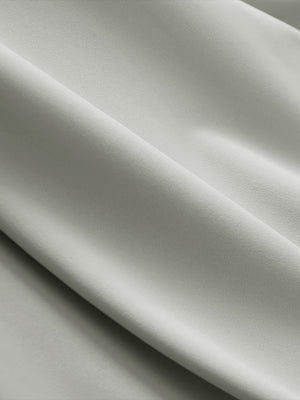 Close-up texture of silver gray breathable casual slacks with 4 pockets fabric showing detailed breathable material and weave.