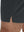 Detail view of hem on dark grey breathable running shorts with 4 zipper pockets