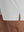 Detail view of hem on white breathable running shorts with 4 zipper pockets