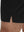 Detail view of hem on black breathable running shorts with 4 zipper pockets