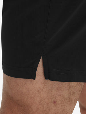 Detail view of hem on black breathable running shorts with 4 zipper pockets