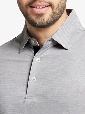 Model front close-up from nose to chest wearing Ventilated Heather Jacquard Polo in FADED DENIM HEATHER
