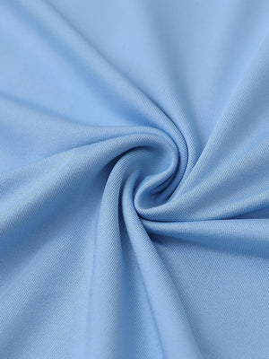 Close-up of light blue everyday solid jersey polo fabric showing soft knit texture and smooth surface.