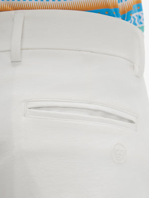 Close-up of the back pocket detail on the white youth water resistant cotton blend golf pants, emphasizing storage