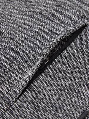Close-up of jacket pocket showing fine stitching and insulation detail, textured insulated winter jacket, black heather.