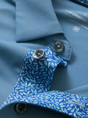 Detail of the collar opening on the misty blue everyday classic solid polo, emphasizing the structured neckline design