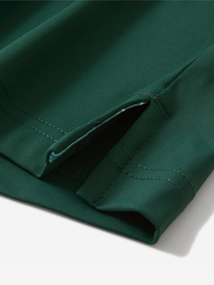 Detail of the side vent hem on the blackish green everyday classic solid polo, showing the split hem feature