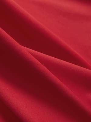 Close-up of red Moisture-Wicking Short Sleeve Henley Shirt fabric texture.