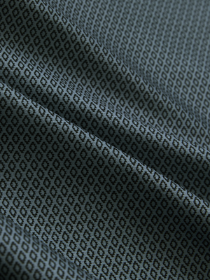 Close-up of gray geo lightweight stretch upgraded print golf polo shirts, showcasing texture and print details.