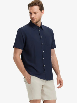 Half-body front view holding a golf club, wearing the NAVY polo on the course.