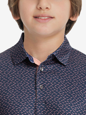 Front view of youth wearing navy pink seagull performance print boys golf polo, showing collar and chest fit